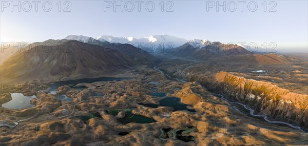 Atmospheric aerial view, high mountain landscape with glacier moraines and mountain lakes, behind Pik Lenin, Trans Alay Mountains, Pamir Mountains, Osher Province, Kyrgyzstan, Asia