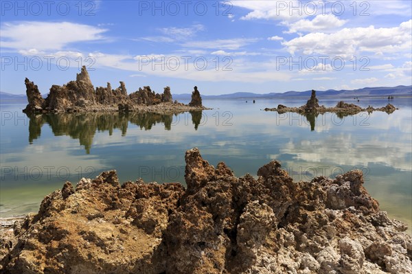 Tranquil lake landscape with unique rock formations and reflections in the water under a blue sky, Mono Lake, North America, USA, South-West, California, California, North America