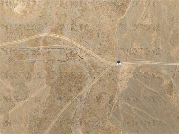 Aerial view, Vast empty landscape, Road and off-road vehicle, Top down view, Two paths divide, Symbolic for decisions, Moldo Too mountains, Naryn region, Kyrgyzstan, Asia
