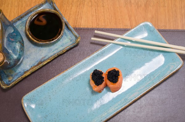 Combined of differents japanese sushi on a elegant blue plate