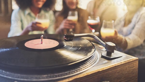 Friends enjoy drinks vinyl record playing together in cozy setting at sunset, bokeh effect ai generated, AI generated