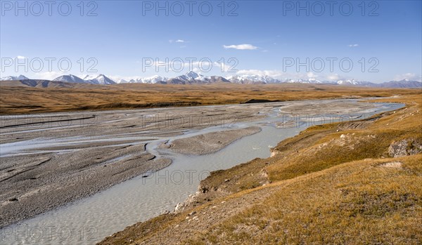 Mountain valley with meandering Sary Jaz River in the morning light, high glaciated mountain peaks of the Tien Shan in the background, autumn mountains with yellow grass, Tien Shan, Kyrgyzstan, Asia