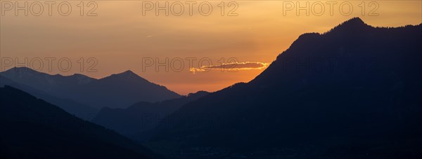 Sunset over mountain peaks, clouds in the evening light after sunset, panoramic shot, view from the lowlands, Leoben, Styria, Austria, Europe