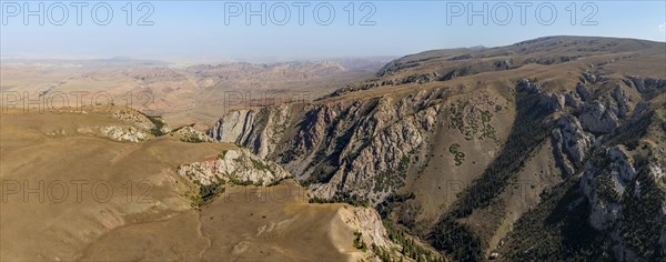 Moldo-Ashuu Pass, mountain landscape with steep rocks between yellow hills, near Baetov, Naryn region, Kyrgyzstan, Asia