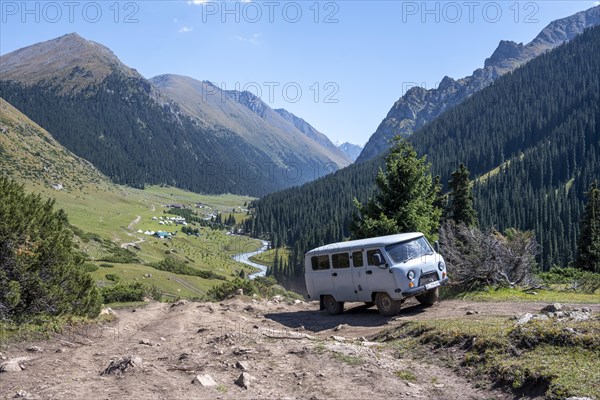 UAZ Buchanka, Russian off-road vehicle on 4x4 track, green mountain valley with village Altyn Arashan, Tien Shan Mountains, Kyrgyzstan, Asia