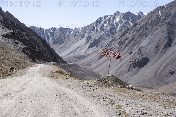 Warning sign at the mountain pass, Dangerous gravel road in the mountains in the Tien Shan, Engilchek Valley, Kyrgyzstan, Issyk Kul, Kyrgyzstan, Asia