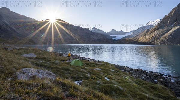 Hiker, camping in the wilderness, mountain lake in the Tien Shan, Lake Ala-Kul, Kyrgyzstan, Asia