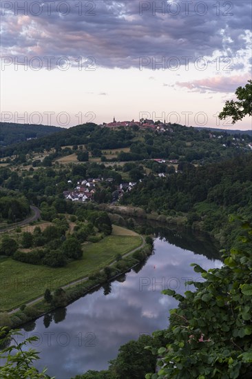 Landscape in the Little Odenwald, view of the village of Dilsberg and the Dilsberg castle fortress as well as the village of Rainbach and the Neckar river. Forests and fields. View from the Bockfelsenhuette. In the evening at sunset in summer. Neckargemuend, Baden-Wuerttemberg, Germany, Europe