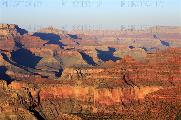 Warm evening light illuminates the majestic red rocks of the Grand Canyon, Grand Canyon National Park, South Rim, North America, USA, South-West, Arizona, North America