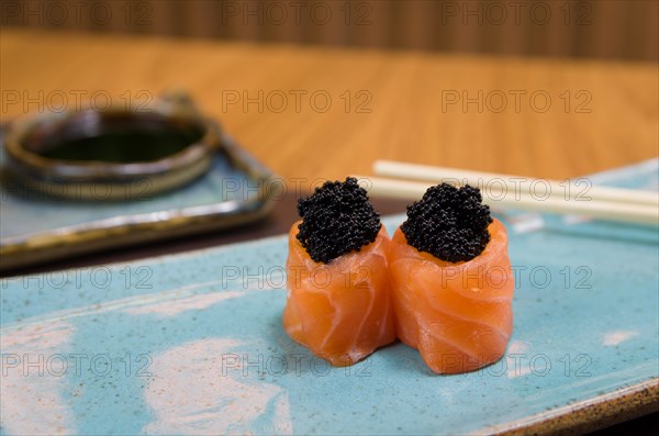 Combined of differents japanese sushi on a elegant blue plate