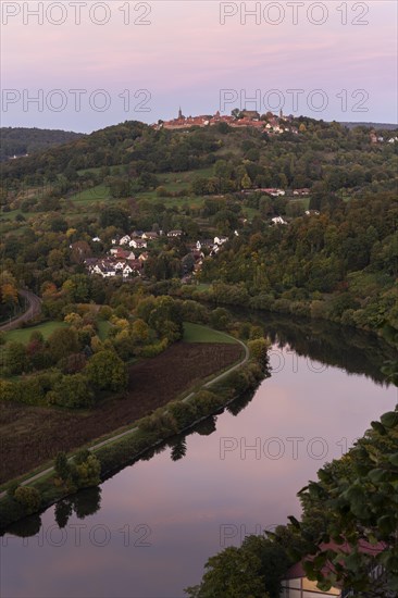 Landscape in the Little Odenwald, view of the village of Dilsberg and the Dilsberg castle fortress as well as the village of Rainbach and the Neckar river. Forests and fields. View from the Bockfelsenhuette. In the evening at sunset in autumn. Neckargemuend, Baden-Wuerttemberg, Germany, Europe
