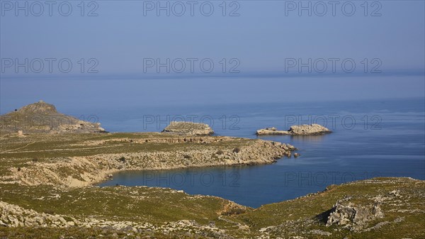 Rocky coastal landscape with small islands and clear blue water, Lindos, Rhodes, Dodecanese, Greek Islands, Greece, Europe