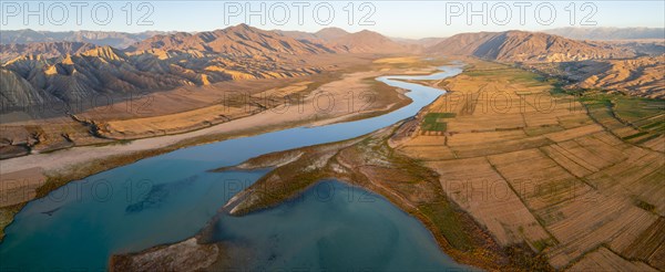 Naryn River between mountains and fields, at Toktogul Reservoir at sunset, aerial view, Kyrgyzstan, Asia