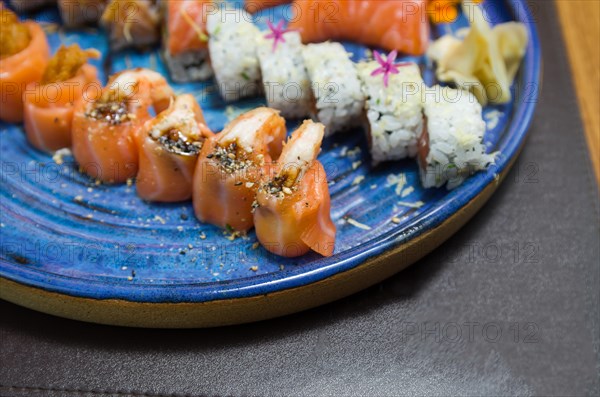 Combined of differents japanese sushi on a elegant blue plate