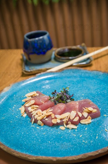 Delicious premium tuna sashimi arranged on an elegant handmade platter