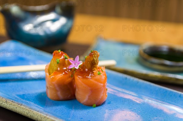 Combined of differents japanese sushi on a elegant blue plate