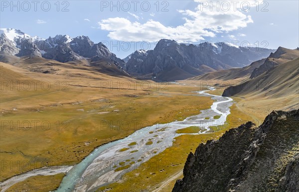 Aerial view, River Kol Suu winds through a mountain valley with hills covered with yellow grass, Pointed high mountain peaks with glaciers, Keltan Mountains, Sary Beles Mountains, Tien Shan, Naryn Province, Kyrgyzstan, Asia