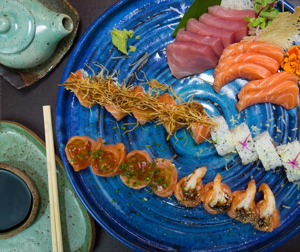Combined of differents japanese sushi on a elegant blue plate