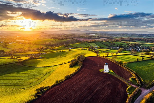 Sunset of Devon Windmill over Fields and Farms from a drone, Torquay, Devon, England, United Kingdom, Europe