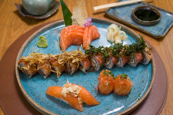 Combined of differents japanese sushi on a elegant blue plate