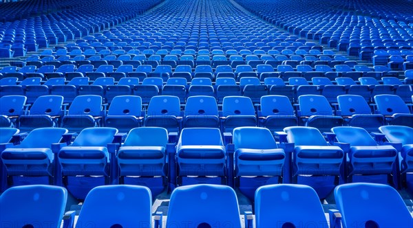 Big empty stadium full of blue seats, AI generated