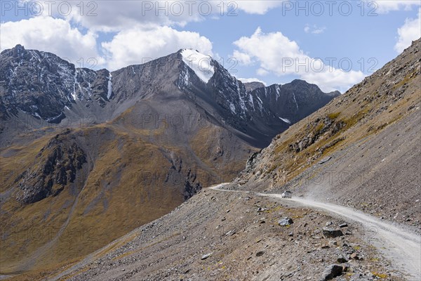 Off-road car on mountain pass, gravel road in the mountains in Tien Shan, Engilchek Valley, Kyrgyzstan, Issyk Kul, Kyrgyzstan, Asia