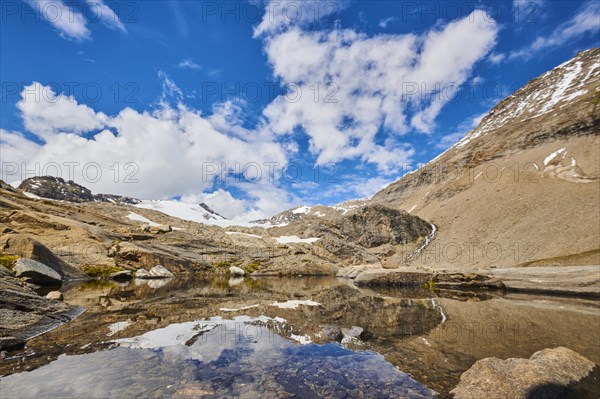 Puddle next to Wasserfallwinkelkeesee in the mountains (Grossglockner) in summer on a sunny day, Kaernten, Austria, Europe
