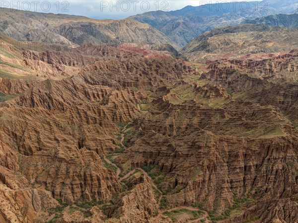 Badlands, river in a gorge with eroded red sandstone rocks, Konorchek Canyon, Boom Gorge, aerial view, Kyrgyzstan, Asia