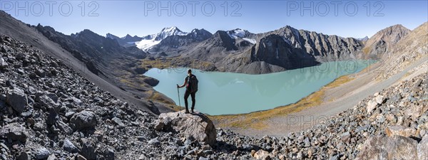 Trekking, hiker in the Tien Shan high mountains, mountain lake Ala-Kul Lake, 4000 metre peak with glacier, Ak-Su, Kyrgyzstan, Asia