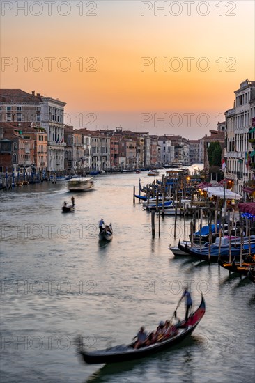 Long exposure, view over the Grand Canal with gondolier at sunset, from the Rialto Bridge, Venice, Veneto, Italy, Europe