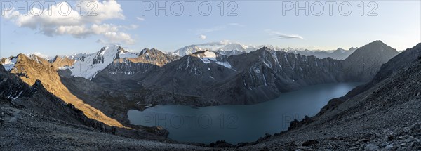Panorama, turquoise mountain lake Ala Kul Lake, mountain peaks with glaciers glow orange at sunset, Ala Kul Pass, Tien Shan Mountains, Kyrgyzstan, Asia