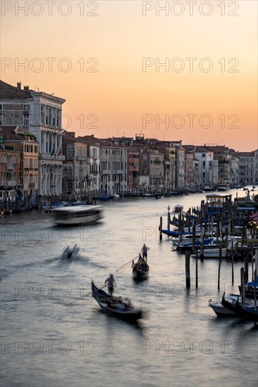 Long exposure, view over the Grand Canal with gondolier at sunset, from the Rialto Bridge, Venice, Veneto, Italy, Europe