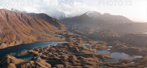 Atmospheric aerial view, high mountain landscape with glacier moraines and mountain lakes, behind Pik Lenin, Trans Alay Mountains, Pamir Mountains, Osher Province, Kyrgyzstan, Asia