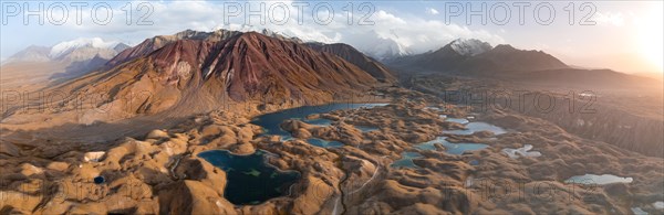 Atmospheric aerial view, high mountain landscape with glacier moraines and mountain lakes, behind Pik Lenin, Trans Alay Mountains, Pamir Mountains, Osher Province, Kyrgyzstan, Asia