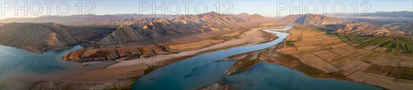 Panorama, Naryn river between mountains and fields, at Toktogul reservoir at sunset, aerial view, Kyrgyzstan, Asia