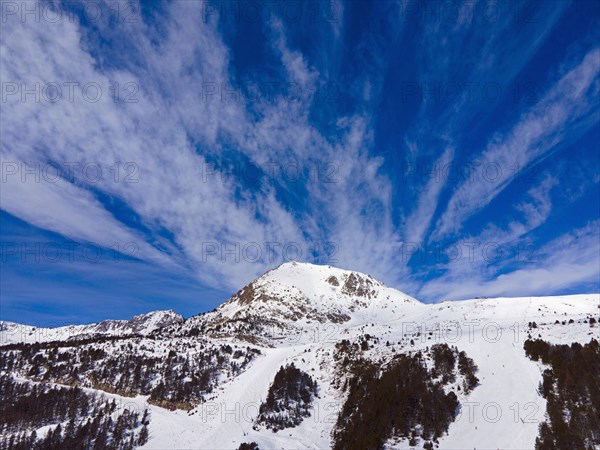 Dynamic sky over a snowy mountain peak in the alpine landscape, Grau Roig, Encamp, Andorra, Pyrenees, Europe