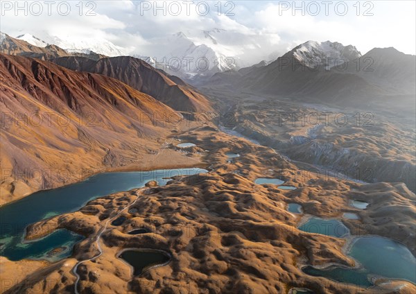 Atmospheric aerial view, high mountain landscape with glacier moraines and mountain lakes, behind Pik Lenin, Trans Alay Mountains, Pamir Mountains, Osher Province, Kyrgyzstan, Asia