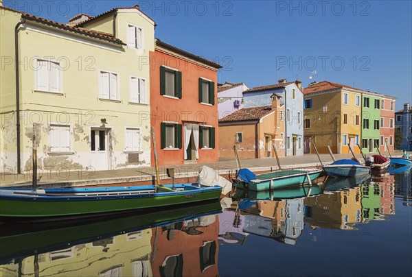 Moored green and blue boats on canal lined with colourful stucco houses, Burano Island, Venetian Lagoon, Venice, Veneto, Italy, Europe