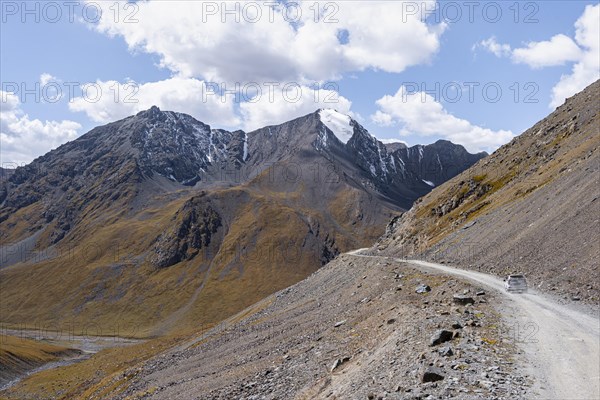 Off-road car on mountain pass, gravel road in the mountains in the Tien Shan, Engilchek Valley, Kyrgyzstan, Issyk Kul, Kyrgyzstan, Asia