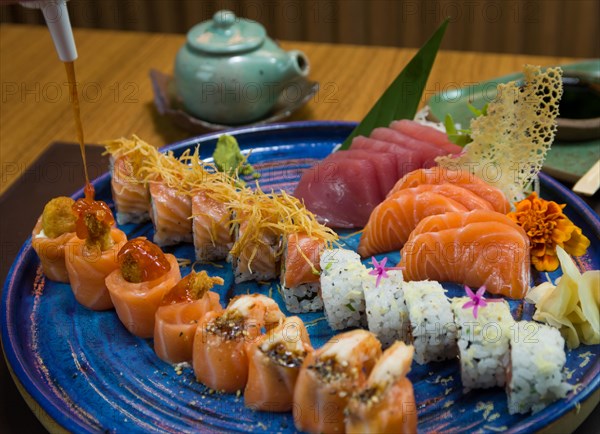 Combined of differents japanese sushi on a elegant blue plate