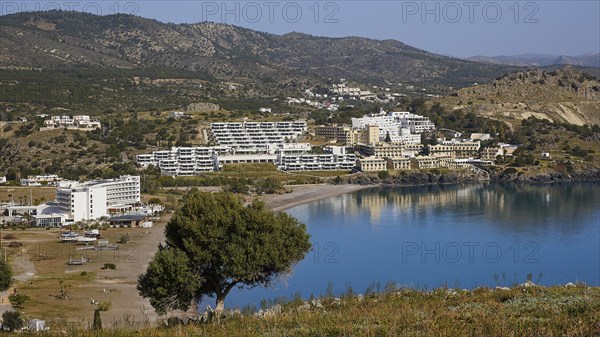 View of a picturesque coastal landscape with beach and hotel complexes, Lindos, Rhodes, Dodecanese, Greek Islands, Greece, Europe