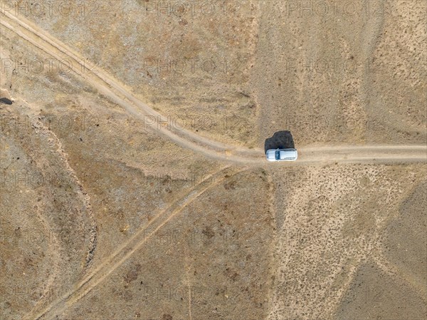 Aerial view, Vast empty landscape, Road and off-road vehicle, Top down view, Two paths divide, Symbolic for decisions, Moldo Too mountains, Naryn region, Kyrgyzstan, Asia