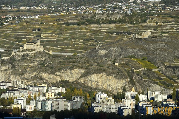 The church of Notre-Dame de Valere, Basilica of Valeria on Valeria Hill, left, and the ruins of Tourbillon Castle, right, above the town of Sion in the Rhone Valley, Sion, Sion, Valais, Switzerland, Europe