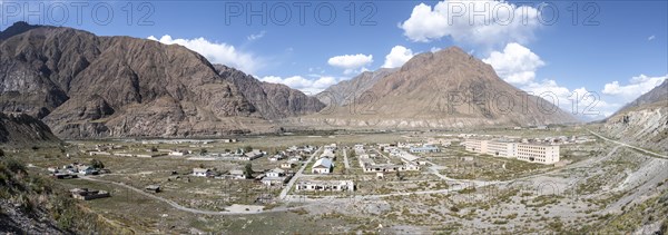 Town view, Abandoned buildings in barren landscape, Ghost town Enilchek in the Tien Shan Mountains, Ak-Su, Kyrgyzstan, Asia
