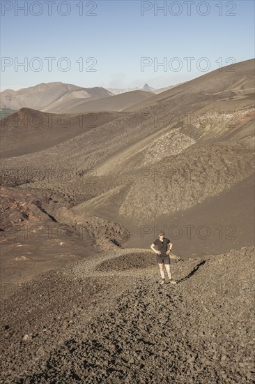Young woman walking through lava fields, Crater Navidad, Lonquimay volcano, Malalcahuello National Reserve, Curacautin, Araucania, Chile, South America