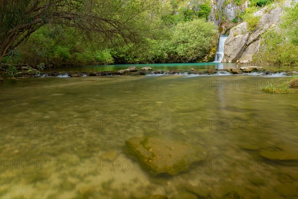 Waterfall of a mountain river with lush vegetation silk effect long exposure photography