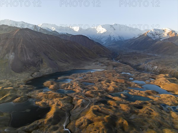 Atmospheric aerial view, high mountain landscape with glacier moraines and mountain lakes, behind Pik Lenin, Trans Alay Mountains, Pamir Mountains, Osher Province, Kyrgyzstan, Asia