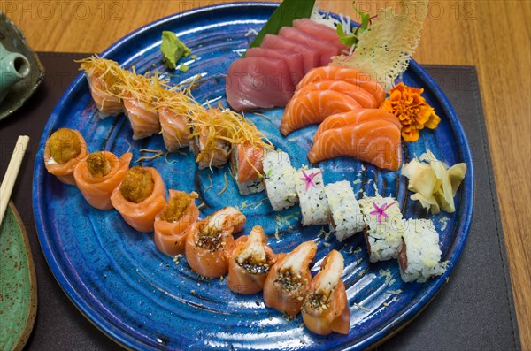 Combined of differents japanese sushi on a elegant blue plate