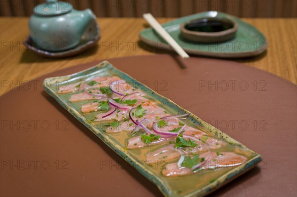 Delicious premium salmon sashimi arranged on an elegant handmade platter