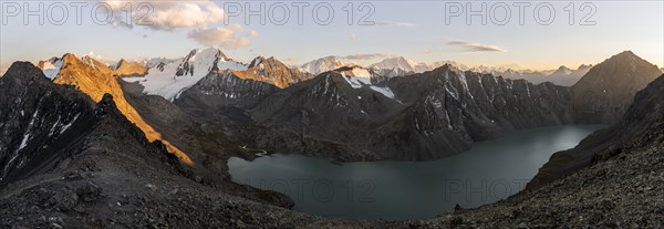 Panorama, Turquoise mountain lake Ala Kul Lake, Mountain peaks with glaciers glow red at sunset, Ala Kul Pass, Tien Shan Mountains, Kyrgyzstan, Asia